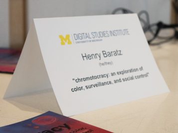 Photo of Henry Baratz's paper nameplate by his project's "chromotocracy" book on a table.